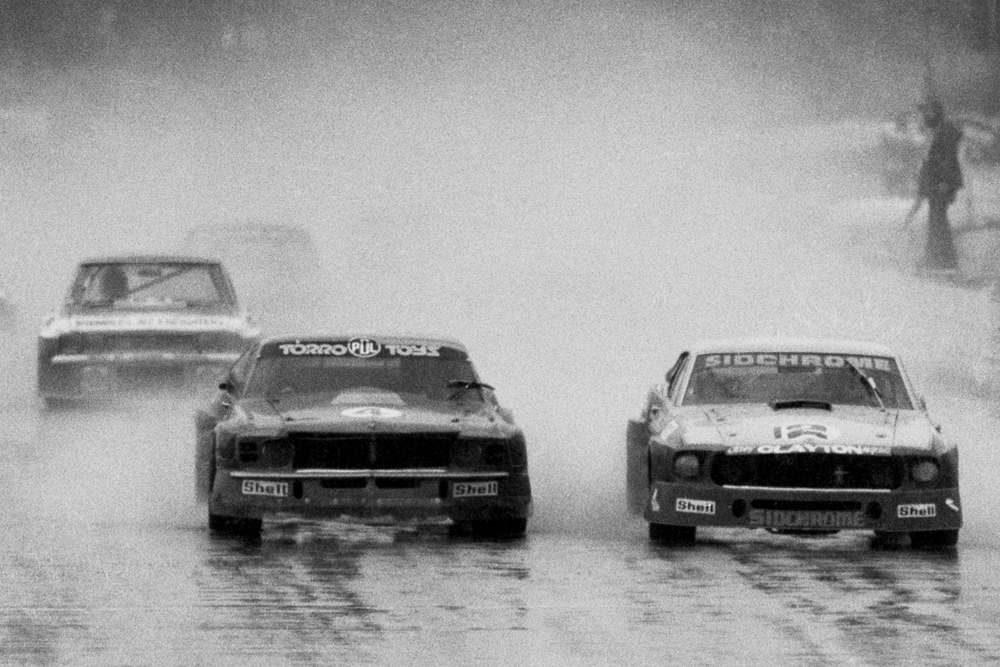A very wet Manfeild 1976. Leo Leonard PDL Ford Mustang leads Jim Richards Sidchrome Ford Mustang chased by Jack Nazer in Miss Victorious. IMAGE/terry marshall