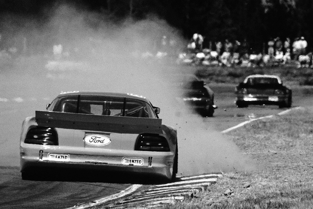 Ruapuna 1996. Over the curbs and into the flying debris. Steve Johnson in the TraNZam Ford Mustang. IMAGE/terry marshall