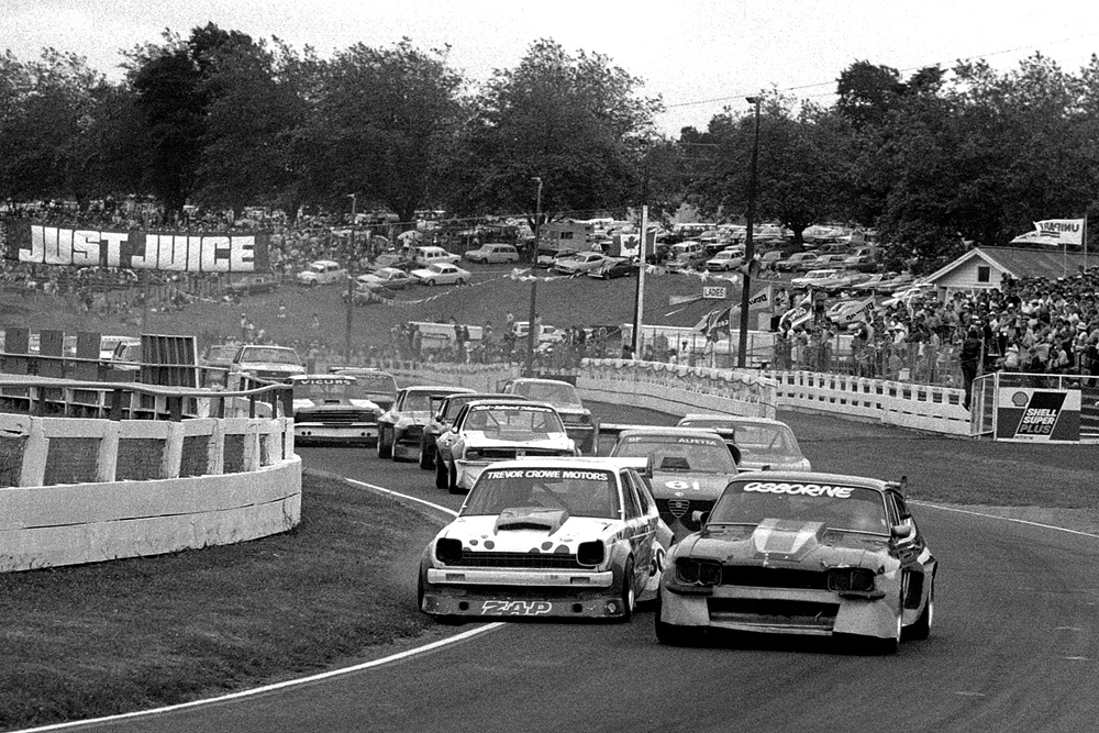 Pukekohe 1983. NZIGP meeting. The start of a Sports Sedan heat. John Osbourne's V8 powered Ford Capri leads out Trevor Crow's V8 powered Toyota Starlet. IMAGE/terry marshall