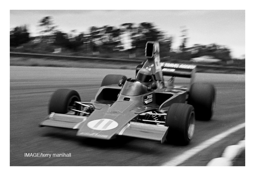 Ruapuna 1976. Ken Smith and his favorite race car the Lola T332 (HU8) blasts passed my feet around Ruapuna's Rothmans sweeper. IMAGE/terry marshall